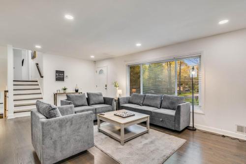 a living room with two couches and a table at Spacious Decatur Home Sleeps 12, Work-Ready in Decatur