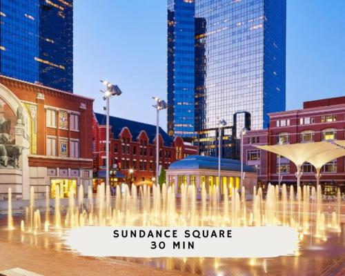 a fountain in the middle of a city with buildings at 4-BD 2-BA Home Retreat Laundry Backyard in Weatherford