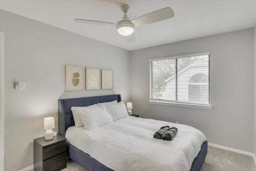 a bedroom with a bed with a pair of shoes on it at Perfect Getaway Home w 5 Bedrooms & Backyard Oasis in Plano