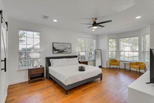 a bedroom with a bed and a ceiling fan at Luxury Mansion Paradise - Cinema Room, Pool, Spa in Rowlett