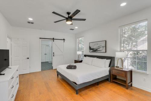 a bedroom with a bed and a ceiling fan at Luxury Mansion Paradise - Cinema Room, Pool, Spa in Rowlett