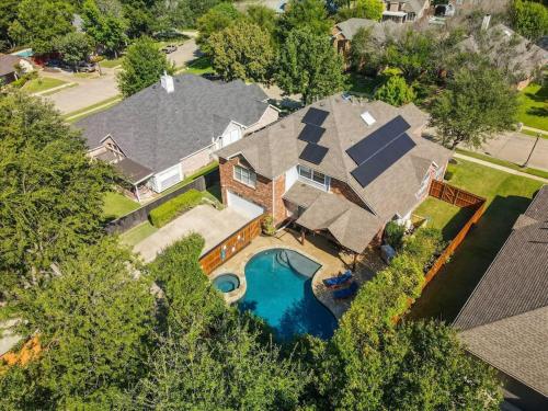 an aerial view of a house with a swimming pool at Luxury Mansion Paradise - Cinema Room, Pool, Spa in Rowlett