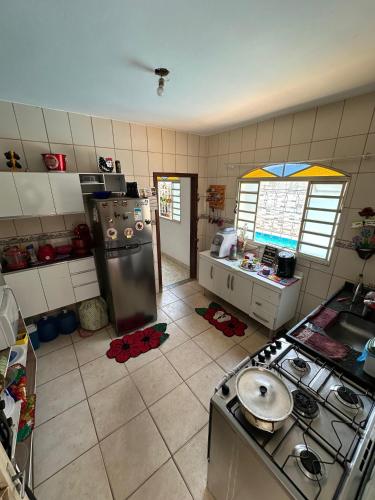 a kitchen with a sink and a stove in it at Hostel Aconchego in Brumadinho