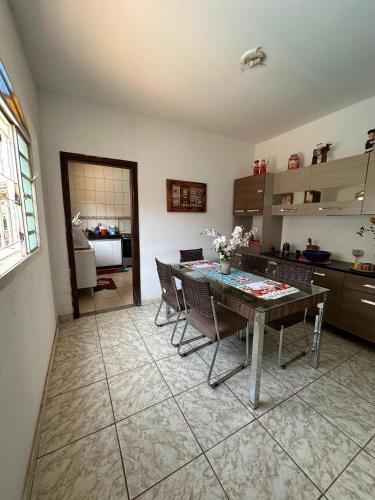 a kitchen with a table and chairs in a room at Hostel Aconchego in Brumadinho