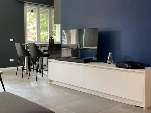 a living room with a tv on a white entertainment center at Family house by Sarah in Valmadrera