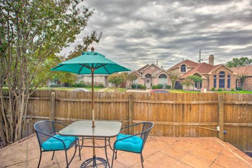 a table and chairs with an umbrella on a patio at Heart of Rowlett - 3 BD 2BA Cozy Getaway w Patio in Rowlett