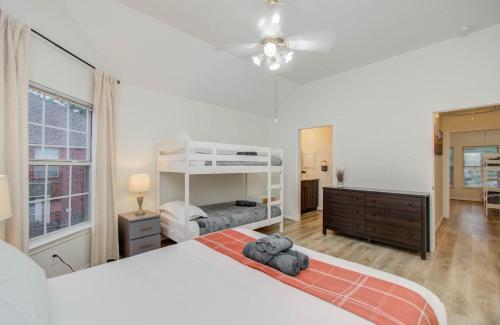 a bedroom with a large white bed and a dresser at Big Texas Living - Spacious 5-BD with Pool in Cypress