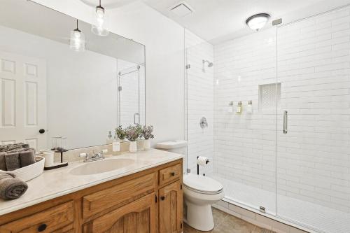 a bathroom with a sink and a toilet and a shower at 3BD Farmhouse Country Living - Pool Patio Firepit in McKinney