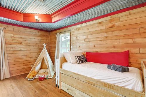 a room with a bed in a log cabin at 3BD Farmhouse Country Living - Pool Patio Firepit in McKinney