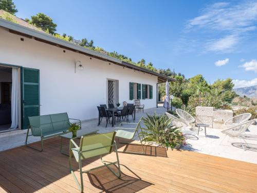 a deck with chairs and a table on a house at Villa Moon Total Relax in Alcamo