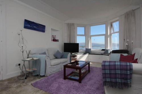 a living room with a couch and a table at Fairview Millport in Millport