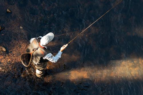a man is holding on to a rope at Tu Tu'Tun Lodge in Gold Beach