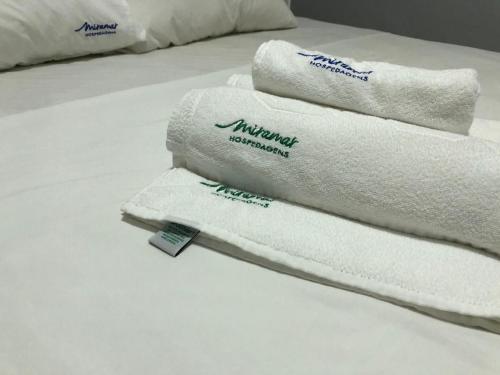 a pile of towels sitting on top of a bed at Move - Tambaú in Tambaú
