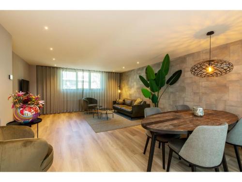 a living room with a table and a couch at Apartment in Domburg near the Beach in Domburg