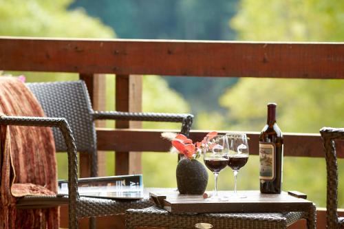 a table with two glasses of wine and a bottle at Tu Tu'Tun Lodge in Gold Beach