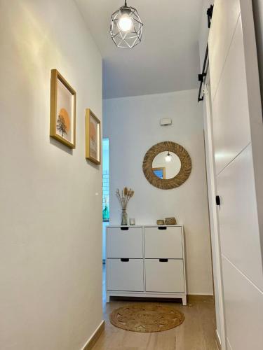 a hallway with a white dresser and a mirror at Casa La Cañada in San Sebastián de la Gomera