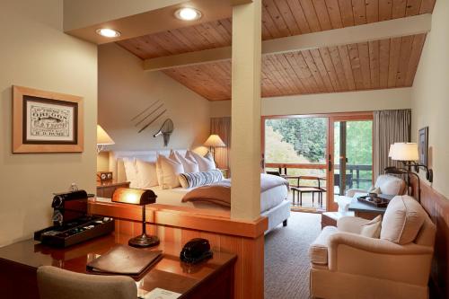 a bedroom with a large bed and a balcony at Tu Tu'Tun Lodge in Gold Beach