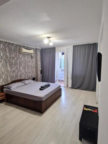 a bedroom with a bed and a television in it at Studio modern. in Bucharest
