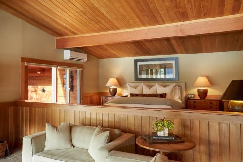a bedroom with a bed and a couch at Tu Tu'Tun Lodge in Gold Beach