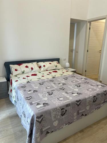 a bedroom with a bed with a blanket on it at RussoHome in Monte di Procida