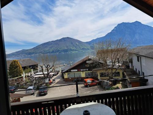 a view of a town with a lake and mountains at Ferienwohnung direkt am See 3 in Altmünster