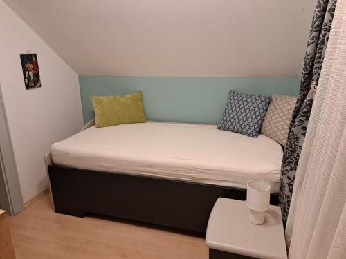 a small bed in a small room with a bed frame at Ferienwohnung direkt am See 3 in Altmünster