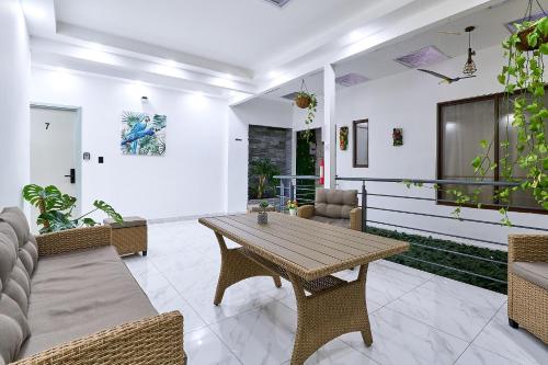 a living room with a wooden table and chairs at Apartaestudios La capital in San José