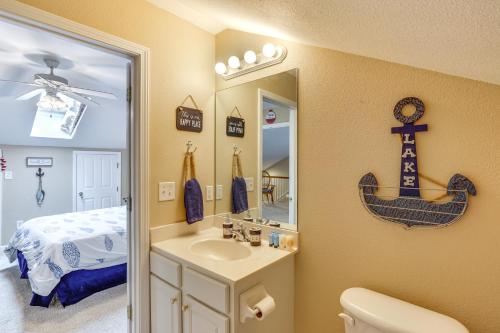 a bathroom with a sink and a mirror and a bed at Lakefront Camdenton Condo Near Ha Ha Tonka and Golf! in Camdenton