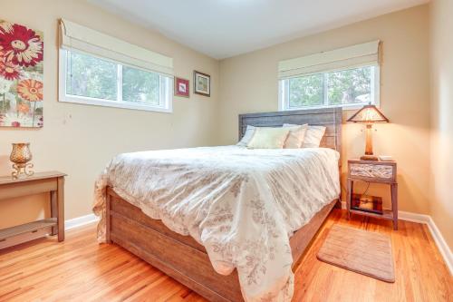 a bedroom with a large bed and two windows at 8 Mi to Lake Bowdoin Pet-Friendly Family Home! in Malta