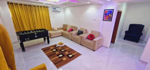 a living room with a couch and a piano at Omega Rest in Lagos