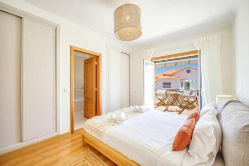 a bedroom with a bed and a large window at Villa Serenity Tapada - Pool, Cinema Room & Gym in Nazaré