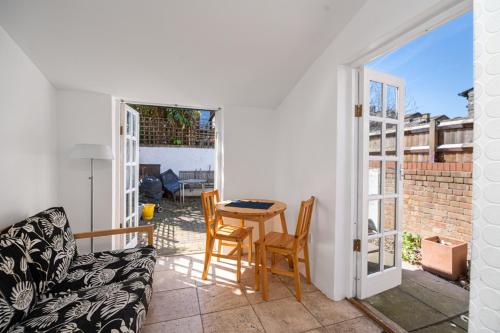 a living room with a table and chairs on a balcony at Bright Spacious Double Bedroom in London