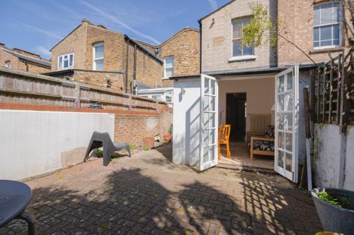 an open door of a house with a patio at Bright Spacious Double Bedroom in London