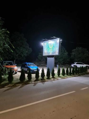 a sign on the side of a road at night at ATOS Srebrno jezero - Villa and Restaurant in Veliko Gradište