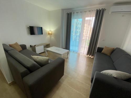 a living room with two couches and a television at Best Summer Apartment in Golem