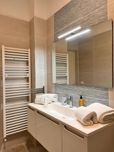 a bathroom with a sink and a mirror at Trend22 Guest House in Pisa