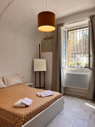 a bedroom with a bed with two towels on it at Trend22 Guest House in Pisa