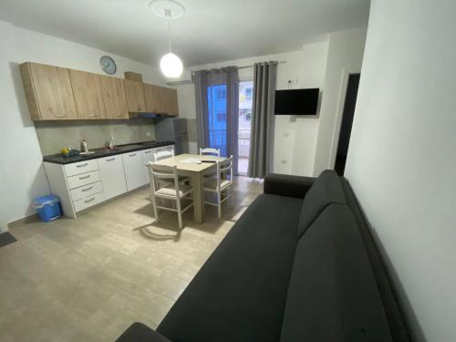 a living room with a couch and a kitchen at Best Summer Apartment in Golem