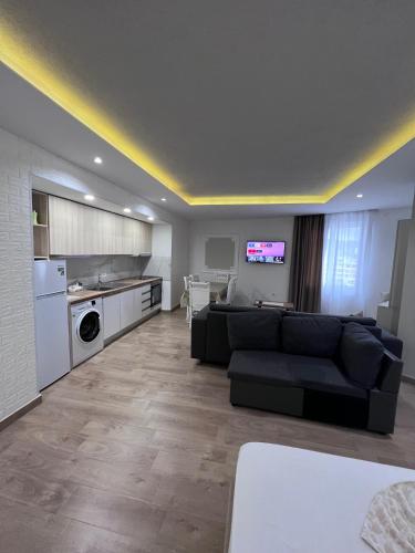 a living room with a couch and a kitchen at Best Summer Apartment in Golem
