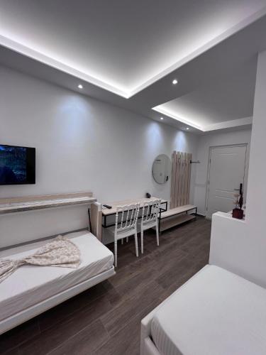 a room with two beds and a desk in it at Best Summer Apartment in Golem