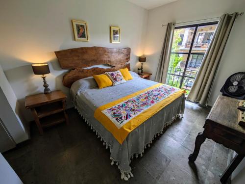a bedroom with a large bed and a window at Casa Kora by Avelia in San Miguel de Allende
