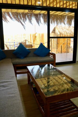 a living room with a couch and a glass table at La Vidita 890 - Piscinas, Lobitos in Lobitos
