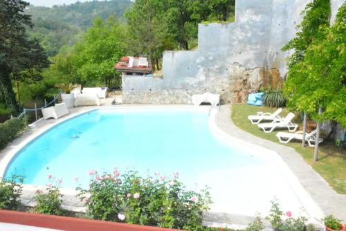 a large swimming pool with lounge chairs around it at Villa Gioia in Acqui Terme
