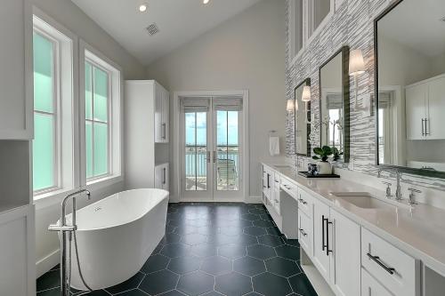 a white bathroom with a tub and two sinks at Keepin' It Reel 234 LAK in Port Aransas