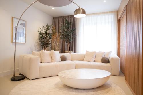 a living room with a white couch and a coffee table at Hotel Cetina Casa de Aguilar in Córdoba