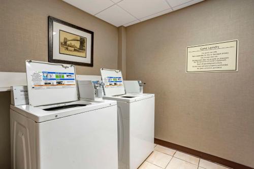 a laundry room with two washers and a dryer at Best Western Plus Kingston Hotel and Conference Center in Kingston