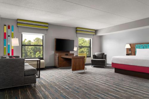 a hotel room with a bed a desk and a tv at Hampton Inn Spring Lake Fayetteville in Spring Lake