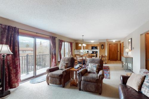 a living room with two chairs and a table at Timber Run Evergreen 9 in Winter Park