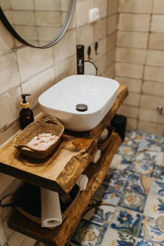 a bathroom with a white sink on a wooden table at La Casita in Almuñécar