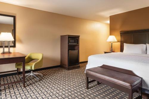 a hotel room with a bed and a desk at Hampton Inn & Suites Pine Bluff in Pine Bluff